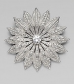 A floral design with a faceted center stone embellished in beautiful stones. Rhodium plated brassCrystalsCubic zirconiaSize, about 2½ Pin backImported 