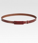 This thin leather style is finished with a small covered buckle tab.About 1 wideMade in Italy