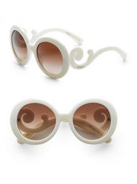 Sophisticated design in a round shape with lavish baroque accents. Available in blue with gradient blue lens, black with gradient gray lens, white with gradient brown lens, tortoise with gradient brown lens, tan with brown gradient lens or havana with purple gradient lens.Acetate frame with APX lens 100% UV protective Made in Italy Sophisticated design in a round shape with lavish baroque accents. Available in blue with gradient blue lens, black with gradient gray lens, white with gradient brown lens, tortoise with gradient brown lens, tan with brown gradient lens or havana with purple gradient lens.Acetate frame with APX lens 100% UV protective Made in Italy