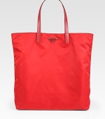 Vela fabric tote with nylon and saffiano leather trim.Double handles, 8 dropEnamel triangle logoPolished steel hardwareOne inside zip pocketPrada logo lining16W X 15H X 3DMade in Italy