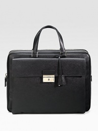 An elegant briefcase in textured saffiano leather with a large envelope exterior pocket. Zip closure Top handles Exterior pocket with clasp closure Interior zip pocket 15¾W X 12H X 2¼D Made in Italy 