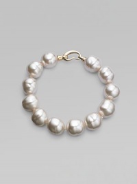An elegant strand of white organic pearls, with a graceful clasp. 14mm white baroque man-made pearls Length, about 8 18k goldplated sterling silver spring clip clasp Made in Spain An elegant strand of white organic pearls, with a graceful clasp. 14mm white baroque man-made pearls Length, about 8 18k goldplated sterling silver spring clip clasp Made in Spain