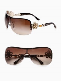 From the Mediterranean Flower Collection. These limited edition frames feature a gentle shield shape with brilliant, crystal accented flower temples. Available in silver/black with grey gradient lens or pale gold/dark brown with brown gradient lens. Crystal accented, flower logo temples100% UV protectionMade in Italy From the Mediterranean Flower Collection. These limited edition frames feature a gentle shield shape with brilliant, crystal accented flower temples. Available in silver/black with grey gradient lens or pale gold/dark brown with brown gradient lens. Crystal accented, flower logo temples100% UV protectionMade in Italy