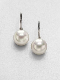 Lustrous white pearls on a sterling silver hoop design. 14mm organic round white man-made pearlSterling silverLength, about .75Post backImported Lustrous white pearls on a sterling silver hoop design. 14mm organic round white man-made pearlSterling silverLength, about .75Post backImported