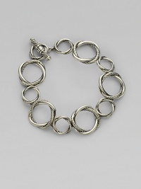 From the Infinity Collection. Graceful, graduated circles, each formed of interwoven strands of smooth and cabled sterling silver, connect to form an elegant bracelet. Sterling silver Length, about 7½ Toggle closure Imported From the Infinity Collection. Graceful, graduated circles, each formed of interwoven strands of smooth and cabled sterling silver, connect to form an elegant bracelet. Sterling silver Length, about 7½ Toggle closure Imported