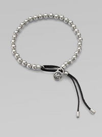 A smooth, beaded design with a logo lock charm and an adjustable leather closure. Silvertone metalDiameter, about 2.5Slip-on style with adjustable leather closureImported A smooth, beaded design with a logo lock charm and an adjustable leather closure. Silvertone metalDiameter, about 2.5Slip-on style with adjustable leather closureImported