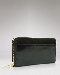 Give into practical accessorizing with this patent Italian leather clutch wallet from Tusk. It's profile is pocket perfect, while a glossy exterior lends polish. Give into practical accessorizing with this patent Italian leather clutch wallet from Tusk. It's profile is pocket perfect, while a glossy exterior lends polish.