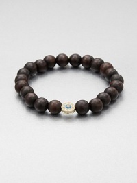 From the Devout Collection. A natural, wood beaded bracelet accented with a diamond and enamel embellished 14k gold evil eye. Wood14k goldDiamonds, .19 tcwLength, about 6.5Slip-on styleImported From the Devout Collection. A natural, wood beaded bracelet accented with a diamond and enamel embellished 14k gold evil eye. Wood14k goldDiamonds, .19 tcwLength, about 6.5Slip-on styleImported