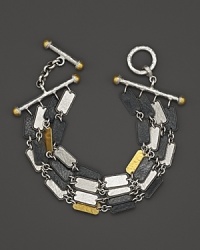 Gold and silver mingle in on his dramatic chain and toggle bracelet from Gurhan. Gold and silver mingle in on his dramatic chain and toggle bracelet from Gurhan.