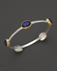 Lapis stations in 24K yellow gold bring vibrant style to this hammered sterling silver bangle from Gurhan. Lapis stations in 24K yellow gold bring vibrant style to this hammered sterling silver bangle from Gurhan.