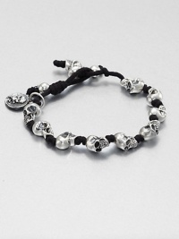 Knotted cord bracelet is interupted with impeccably sculpted skulls of sterling silver for a modern, masculine addition to your accessory collection.Sterling silverWaxed cottonDiameter, about 3Drawstring closureMade in USA Knotted cord bracelet is interupted with impeccably sculpted skulls of sterling silver for a modern, masculine addition to your accessory collection.Sterling silverWaxed cottonDiameter, about 3Drawstring closureMade in USA
