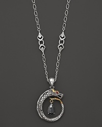 A bold, sterling silver dragon forms a pendant on John Hardy's ruby and 18K gold detailed necklace. A bold, sterling silver dragon forms a pendant on John Hardy's ruby and 18K gold detailed necklace.