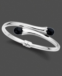 Smooth, lustrous onyx (10 mm) emerges from shining sterling silver on this dramatic bangle bracelet. Approximate diameter: 2-1/2 inches. Smooth, lustrous onyx (10 mm) emerges from shining sterling silver on this dramatic bangle bracelet. Approximate diameter: 2-1/2 inches.