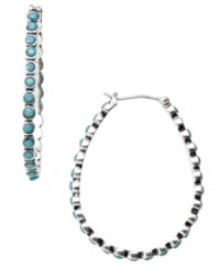 Turquoise teardrops. Fossil's mixed metal silver tone teardrop-shaped hoop earrings feature reconstituted semi-precious turquoise stones. Approximate drop: 1-1/2 inches. Turquoise teardrops. Fossil's mixed metal silver tone teardrop-shaped hoop earrings feature reconstituted semi-precious turquoise stones. Approximate drop: 1-1/2 inches.