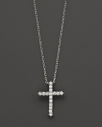 Diamonds, set in 14K white gold, form a chic cross. Diamonds, set in 14K white gold, form a chic cross.