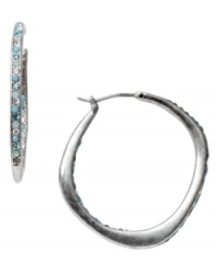 Get your diva on in Fossil's Glitz hoop earrings. Sparkling blue and clear crystals adorn a silver tone mixed metal setting for conversation-sparking style. Approximate diameter: 1-1/3 inches. Get your diva on in Fossil's Glitz hoop earrings. Sparkling blue and clear crystals adorn a silver tone mixed metal setting for conversation-sparking style. Approximate diameter: 1-1/3 inches.