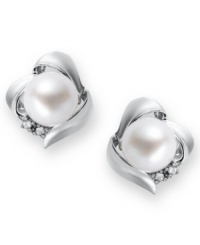 A simple, sophisticated touch. These petite knot-shaped stud earrings feature a cultured freshwater pearl (7 mm) and sparkling diamond accents at the sides. Set in sterling silver. Approximate diameter: 3/8 inch. A simple, sophisticated touch. These petite knot-shaped stud earrings feature a cultured freshwater pearl (7 mm) and sparkling diamond accents at the sides. Set in sterling silver. Approximate diameter: 3/8 inch.