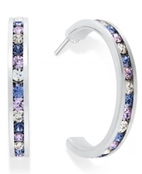 Traditions gives a sparkling boost to a simple pair of hoop earrings. A channel-set row of round-cut purple and blue Swarovski crystals shines within a sterling silver setting. Earrings feature a post and stud backing. Approximate diameter: 3/4 inch. Traditions gives a sparkling boost to a simple pair of hoop earrings. A channel-set row of round-cut purple and blue Swarovski crystals shines within a sterling silver setting. Earrings feature a post and stud backing. Approximate diameter: 3/4 inch.