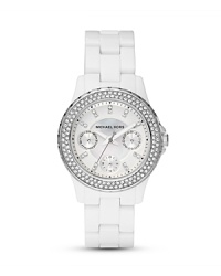A crystal-encrusted bezel sets this chic white watch to sparkle. From MICHAEL Michael Kors. A crystal-encrusted bezel sets this chic white watch to sparkle. From MICHAEL Michael Kors.