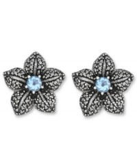 Springtime sparkle. Genevieve & Grace's delicate flower stud earrings feature a round-cut blue topaz center (1 ct. t.w.) with glittering marcasite petals. Crafted in sterling silver. Earrings feature an omega clip-on backing for non-pierced ears. Approximate diameter: 7/8 inch.