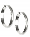 The classic elegance you need, by Jones New York. With a wide, flat design, these sleek hoop earrings bring the change your jewelry box needs. Crafted with silver tone mixed metal. Approximate diameter: 1-1/4 inches.