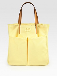 A carryall essential crafted from durable canvas, finished deep front pockets and tanned leather handles.Double leather top handles, 7 dropTwo outside open pocketsOne inside zip pocketCanvas lining11½W X 12½H X 6DImported A carryall essential crafted from durable canvas, finished deep front pockets and tanned leather handles.Double leather top handles, 7 dropTwo outside open pocketsOne inside zip pocketCanvas lining11½W X 12½H X 6DImported