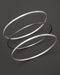 Two striking tones, three beautiful bangles from Gurhan, crafted in hammered white silver and dark silver. Two striking tones, three beautiful bangles from Gurhan, crafted in hammered white silver and dark silver.