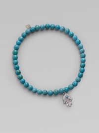 The open hand or hamsa, a traditional symbol of protection in several cultures, is depicted in diamonds set in 14k white gold with a turquoise center, and hangs on a strand of vivid turquoise beads. Diamonds, 0.06 tcw Turquoise 14k white gold Diameter, about 2 Charm length, about ½ Stretch cord Imported The open hand or hamsa, a traditional symbol of protection in several cultures, is depicted in diamonds set in 14k white gold with a turquoise center, and hangs on a strand of vivid turquoise beads. Diamonds, 0.06 tcw Turquoise 14k white gold Diameter, about 2 Charm length, about ½ Stretch cord Imported