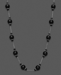 Mysterious loveliness. Show your dark side with this necklace with black onyx beads (4-10 mm). Set in sterling silver. Approximate length: 18 inches.