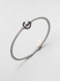 A stunning grey pearl on a textured, rhodium-plated stainless steel bangle. 12mm organic grey round man-made pearlRhodium-plated stainless steelDiameter, about 2.5Slip-on styleImported