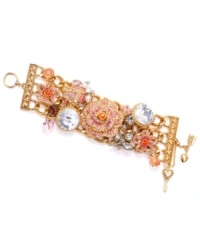 Betsey Johnson takes clustering to a whole new level with this antique gold tone mixed metal bracelet. Crystal leaves, pink faceted beads and crystal accents adorn gold-tone chains. Ombre pave crystals cover gold-tone flowers and a large gold-tone rose. Approximate length: 8 inches.