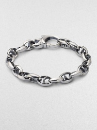 Bold oval links of polished sterling silver have not-so-sinister curved spikes in their centers.Sterling silver Length, about 8½ Lobster clasp Imported