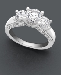 Complete the moment. A breathtaking round-cut solitaire diamond (1 ct. t.w.) with accompanying side diamonds (3/8 ct. t.w.) will be her most-prized possession. A unique engagement ring that features a special side design with diamond accents along the profile of the band. Ring crafted in 18k white gold. IGI Certified diamonds. Complete the moment. A breathtaking round-cut solitaire diamond (1 ct. t.w.) with accompanying side diamonds (3/8 ct. t.w.) will be her most-prized possession. A unique engagement ring that features a special side design with diamond accents along the profile of the band. Ring crafted in 18k white gold. IGI Certified diamonds.