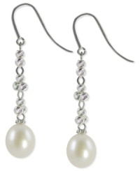 Sleek and sophisticated, this pair of sterling silver earrings dazzles with cultured freshwater pearls (9-9-1/2 mm) offset by rhodium-plated sparkle beads for a lustrous touch. Approximate drop: 1-7/8 inches.