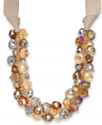Rich, golden sparkle with a chic touch of feminine flair. This c.A.K.e. by Ali Khan necklace features champagne and gold-colored glass bead clusters with a ribbon and gold tone mixed metal setting. Approximate length: 18 inches + 3-inch extender. Approximate drop: 3 inches. Rich, golden sparkle with a chic touch of feminine flair. This c.A.K.e. by Ali Khan necklace features champagne and gold-colored glass bead clusters with a ribbon and gold tone mixed metal setting. Approximate length: 18 inches + 3-inch extender. Approximate drop: 3 inches.
