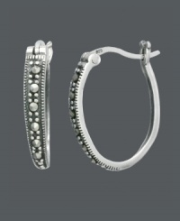 Take traditional hoops to a new level with this standout style by Genevieve & Grace. Oval-shaped hoops feature a polished sterling silver setting and glittering, round-cut marcasite. Approximate diameter: 3/4 inch. Take traditional hoops to a new level with this standout style by Genevieve & Grace. Oval-shaped hoops feature a polished sterling silver setting and glittering, round-cut marcasite. Approximate diameter: 3/4 inch.