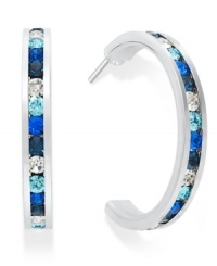 Traditions gives a sparkling boost to a simple pair of hoop earrings. A channel-set row of round-cut blue and clear Swarovski crystals shines within a sterling silver setting. Earrings feature a post and stud backing. Approximate diameter: 3/4 inch. Traditions gives a sparkling boost to a simple pair of hoop earrings. A channel-set row of round-cut blue and clear Swarovski crystals shines within a sterling silver setting. Earrings feature a post and stud backing. Approximate diameter: 3/4 inch.
