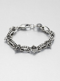 A remarkably detailed fleur de lis of sterling silver and skull charm accents a simple, sophisticated sterling silver bracelet.Sterling silverWidth, about 8mmDiameter, about 3Lobster claspMade in USA A remarkably detailed fleur de lis of sterling silver and skull charm accents a simple, sophisticated sterling silver bracelet.Sterling silverWidth, about 8mmDiameter, about 3Lobster claspMade in USA