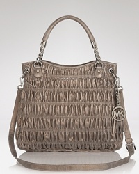 Go both classic and cool with this quilted style from MICHAEL Michael Kors. Featuring a prettified version of a favorite shape - the satchel - this bag lends luxury to every look. Go both classic and cool with this quilted style from MICHAEL Michael Kors. Featuring a prettified version of a favorite shape - the satchel - this bag lends luxury to every look.