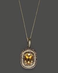 Diamonds and brown diamonds frame a faceted citrine, set in 14K white gold with rhodium details and beautiful gallery backing. Diamonds and brown diamonds frame a faceted citrine, set in 14K white gold with rhodium details and beautiful gallery backing.