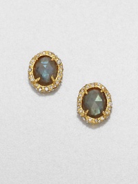 From the Elements Siyabona Collection. The tantalizing iridescence of faceted labradorite is elegantly framed by a spikey golden setting accented with Swarovski crystals in this graceful oval button design.LabradoriteCrystalGoldtoneLength, about .6Width, about .5Post backMade in USA From the Elements Siyabona Collection. The tantalizing iridescence of faceted labradorite is elegantly framed by a spikey golden setting accented with Swarovski crystals in this graceful oval button design.LabradoriteCrystalGoldtoneLength, about .6Width, about .5Post backMade in USA