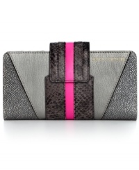 Call of the wild. Tap into the reptilian trend with this snakeskin print wallet from Juicy Couture. Soft leather is outfitted in cool colorblocking with plenty of pockets, making it the ultimate diva-licious design. Call of the wild. Tap into the reptilian trend with this snakeskin print wallet from Juicy Couture. Soft leather is outfitted in cool colorblocking with plenty of pockets, making it the ultimate diva-licious design.