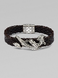 An intricately detailed sterling silver dragon wraps itself around a band of braided leather.SilverBraided leatherPush-lock claspAbout 8½ longAbout ¾ wideImported