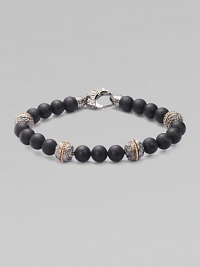 A bold statement in sterling silver and matte onyx with handsome engraved detail. Sterling silver Onyx 8mm beads About 9 long Imported A bold statement in sterling silver and matte onyx with handsome engraved detail. Sterling silver Onyx 8mm beads About 9 long Imported