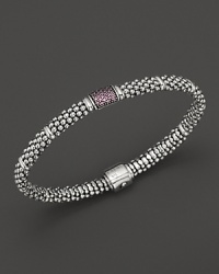 Bead-textured bracelet from Lagos in sterling silver, accented with pink sapphire. Bead-textured bracelet from Lagos in sterling silver, accented with pink sapphire.