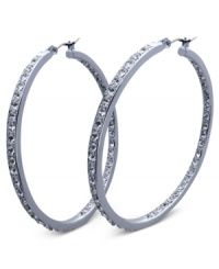 Fashion that covers all bases. These sleek hoop earrings from GUESS sparkle inside and out with glass accents. Crafted in silver tone mixed metal. Approximate diameter: 2 inches. Fashion that covers all bases. These sleek hoop earrings from GUESS sparkle inside and out with glass accents. Crafted in silver tone mixed metal. Approximate diameter: 2 inches.