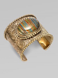 From the Trujillo Collection. An intricately carved, bead-edged cuff, dramatic on its own, has a striated plaque of rainbow calsilica, encased in rock crystal, as its brilliant centerpiece.Rainbow calsilica and rock crystalBronzeDiameter, about 2¼Made in USA From the Trujillo Collection. An intricately carved, bead-edged cuff, dramatic on its own, has a striated plaque of rainbow calsilica, encased in rock crystal, as its brilliant centerpiece.Rainbow calsilica and rock crystalBronzeDiameter, about 2¼Made in USA