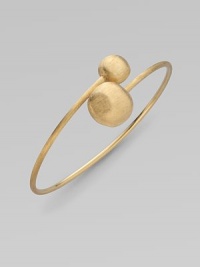 From the Africa Collection. Two textured orbs cross paths along a thin 18k yellow gold band.18k yellow gold Diameter, about 7 Made in Italy From the Africa Collection. Two textured orbs cross paths along a thin 18k yellow gold band.18k yellow gold Diameter, about 7 Made in Italy