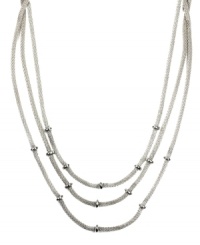 Add just the right amount of layers to amp up your look. AK Anne Klein necklace features three rows of woven chains accented by donut-shaped beads. Crafted in silver tone mixed metal. Approximate length: 16 inches. Add just the right amount of layers to amp up your look. AK Anne Klein necklace features three rows of woven chains accented by donut-shaped beads. Crafted in silver tone mixed metal. Approximate length: 16 inches.