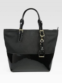 Glossy patent leather mixes with luxe canvas in this roomy design, with a dangling stirrup for western appeal. Adjustable patent leather top handles, 5½-7 dropTop zip closureOne inside zip pocketTwo inside open pocketsCotton lining17W X 13H X 5¾DImported Glossy patent leather mixes with luxe canvas in this roomy design, with a dangling stirrup for western appeal. Adjustable patent leather top handles, 5½-7 dropTop zip closureOne inside zip pocketTwo inside open pocketsCotton lining17W X 13H X 5¾DImported